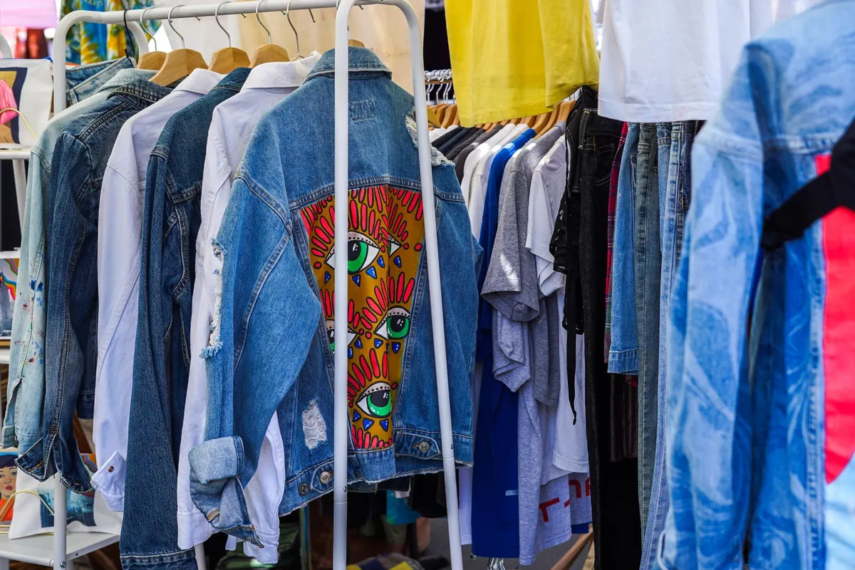 Vestes en jean sur un portant, en illustration de « vendre culotte portée en ligne »